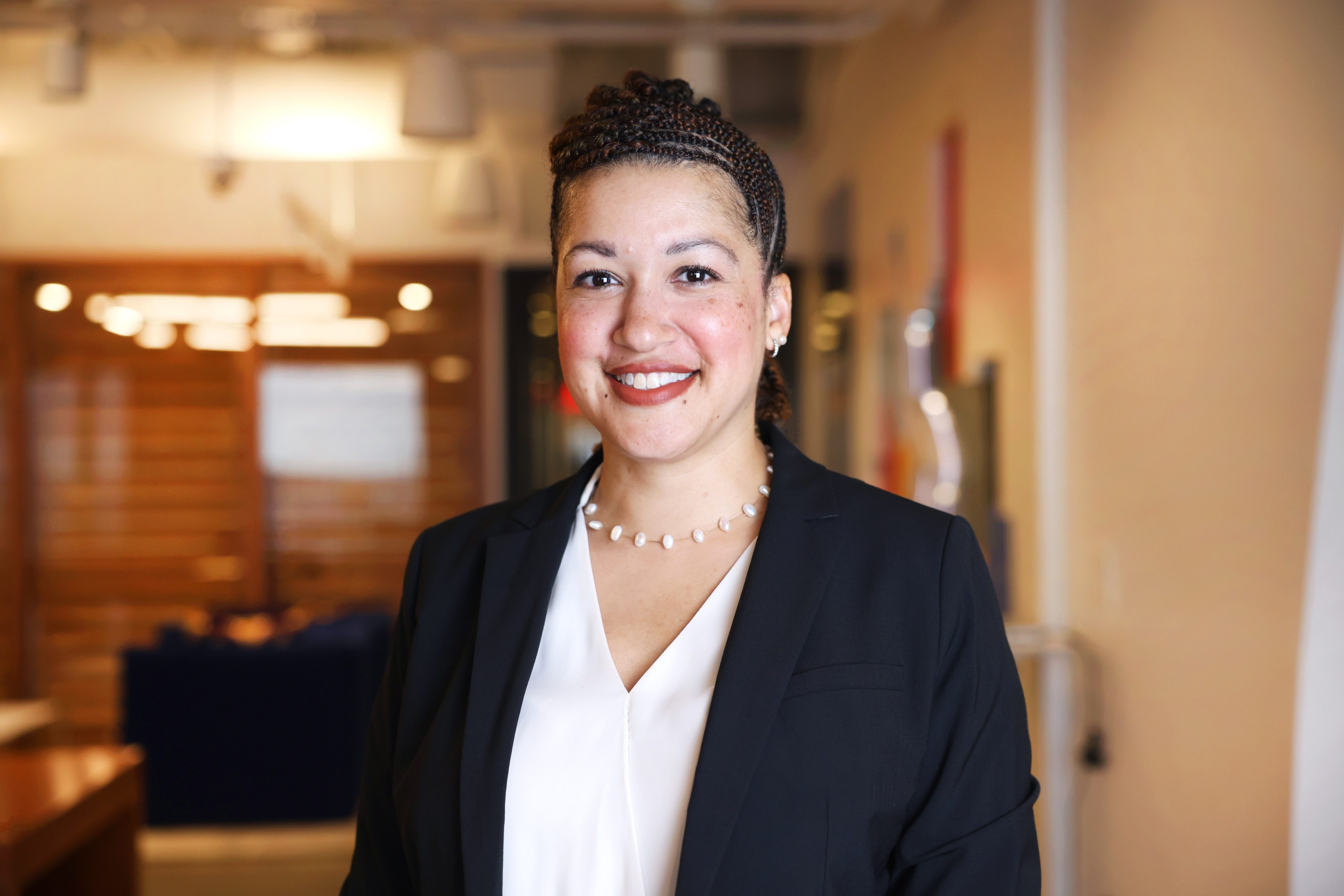 Crystal Diaz-Granados, Founder of Clear Story Coaching, in a modern office lobby